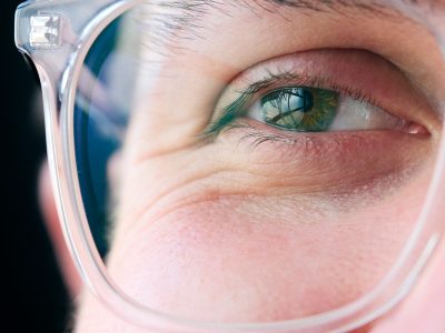 Macro Studio Expression Shot Of Young Man's Eye Wearing Glasses With Close Up On Eyelashes And Pupil